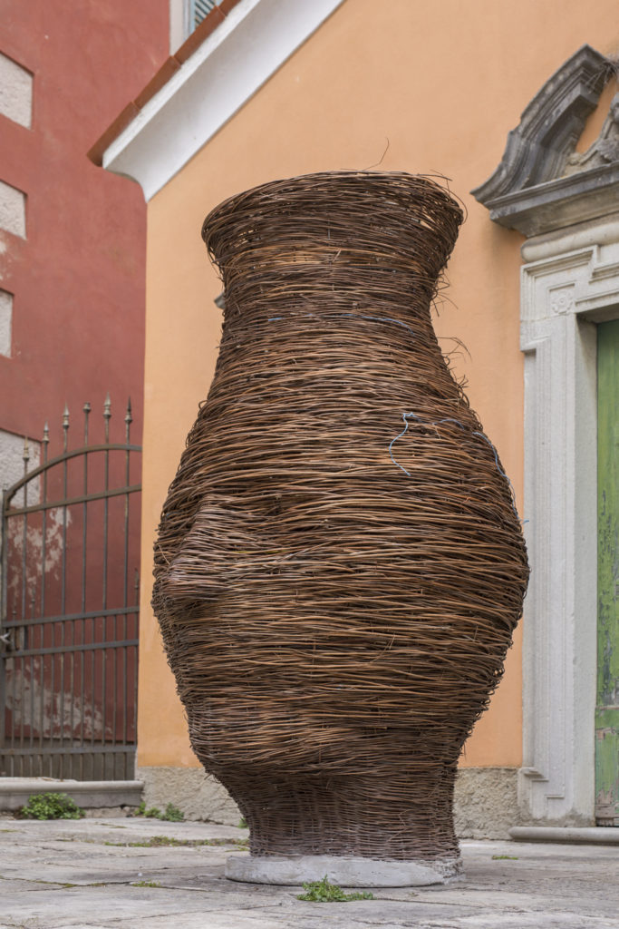 Tanja Helena Roscic, Man in the Bottle, 2023. Metal and willow sculpture on the pavement outside an ancient chapel in Labin.